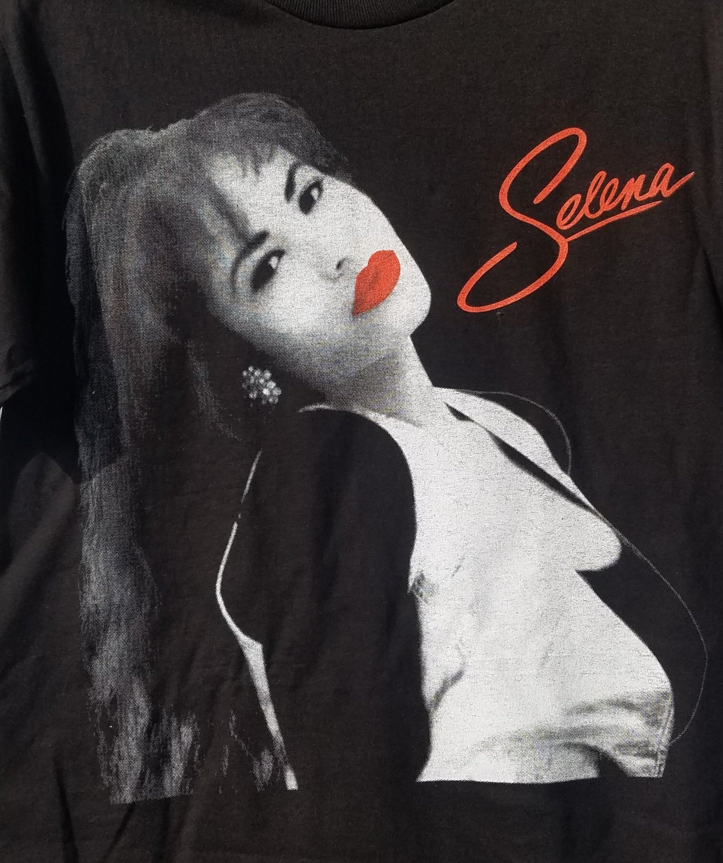 Front view of Selena Red Lips Portrait graphic T-shirt featuring black and white portrait with red lips detail printed in authentic silkscreen on black cotton tee