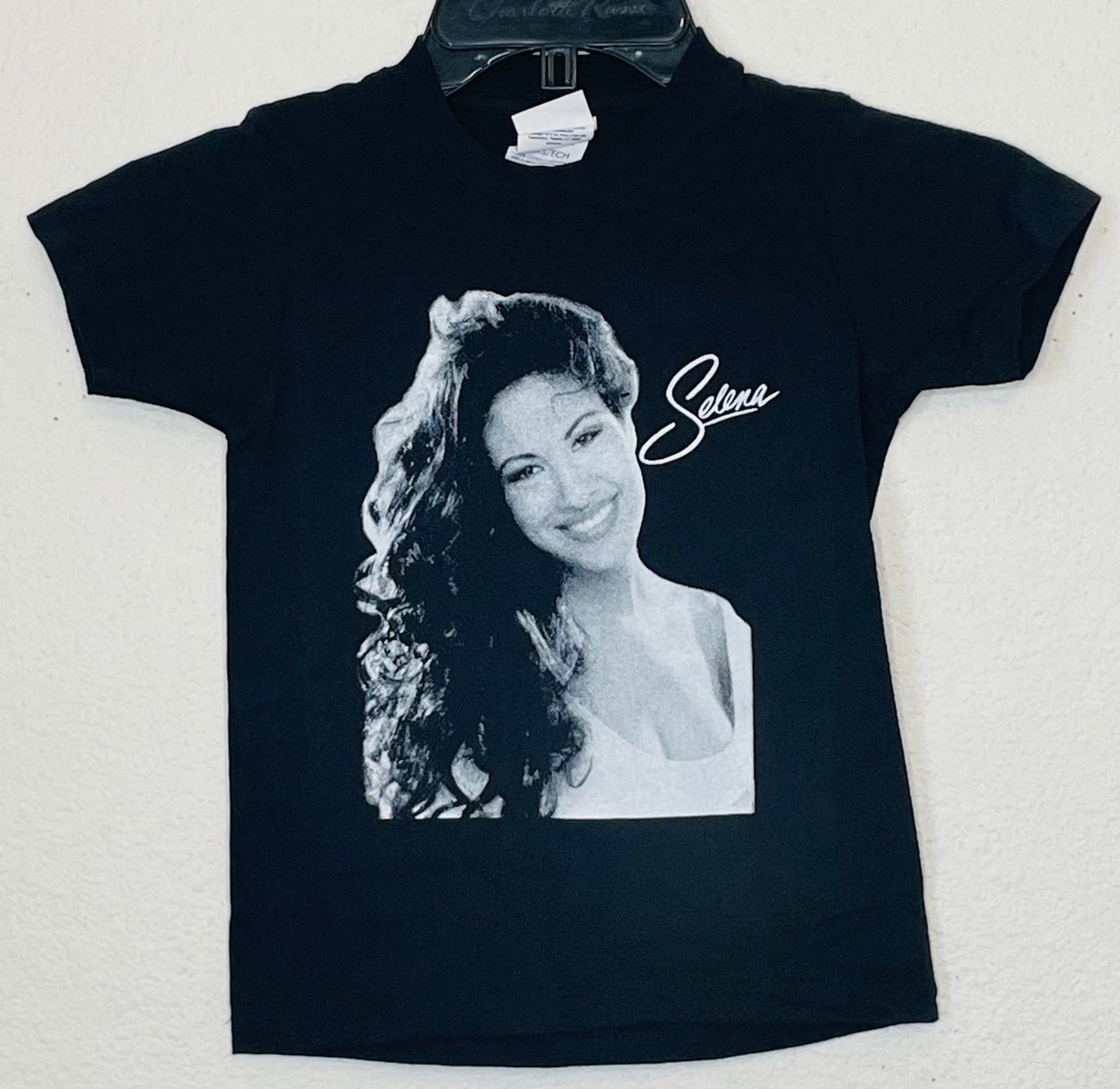 Selena White Script Youth Silkscreen T-Shirt – Tribute to the Queen of Tejano, featuring her iconic signature design. Available in XS-XL.
