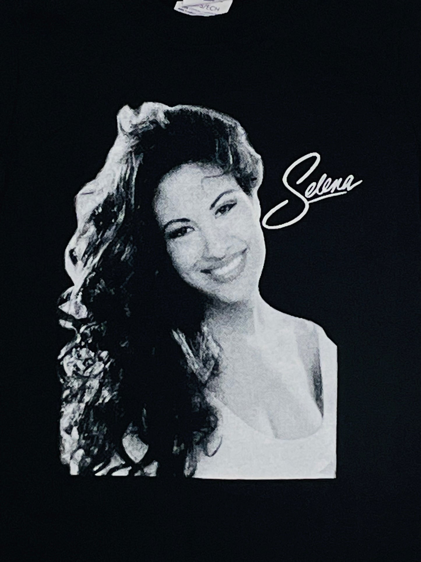 Selena White Script Youth Silkscreen T-Shirt – Tribute to the Queen of Tejano, featuring her iconic signature design. Available in XS-XL.
