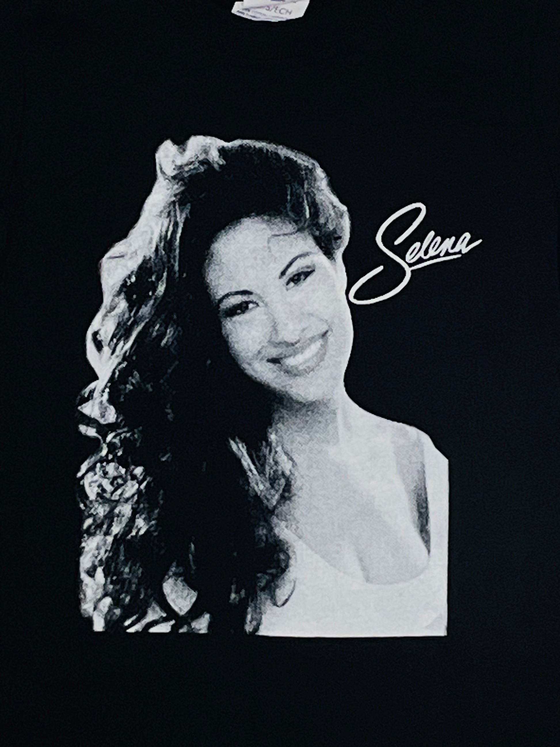 Selena White Script Youth Silkscreen T-Shirt – Tribute to the Queen of Tejano, featuring her iconic signature design. Available in XS-XL.