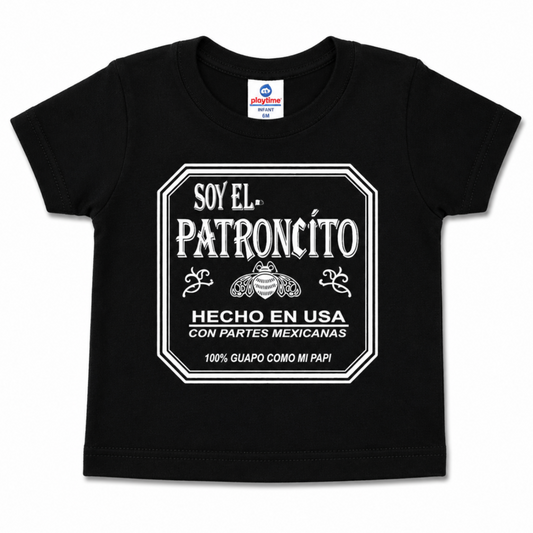Alt Text: Soy El Patroncito black infant graphic T-shirt featuring Hecho en USA con Partes Mexicanas design, sizes 6M-24M.