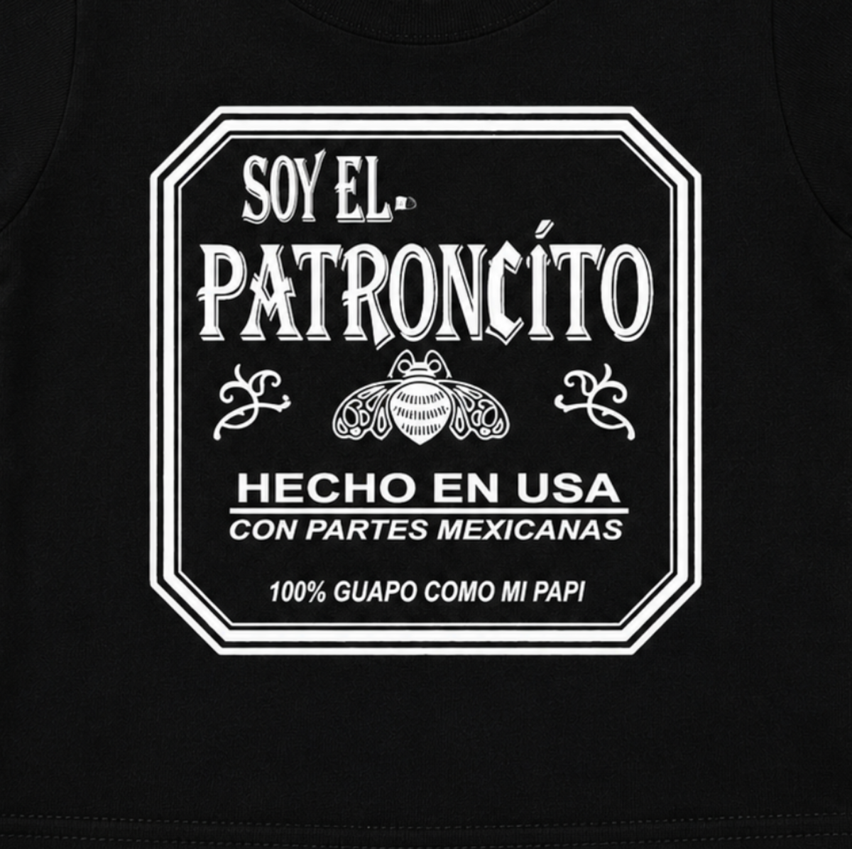 Close-up of the Soy El Patroncito and Hecho en USA con Partes Mexicanas graphic on the black infant T-shirt.