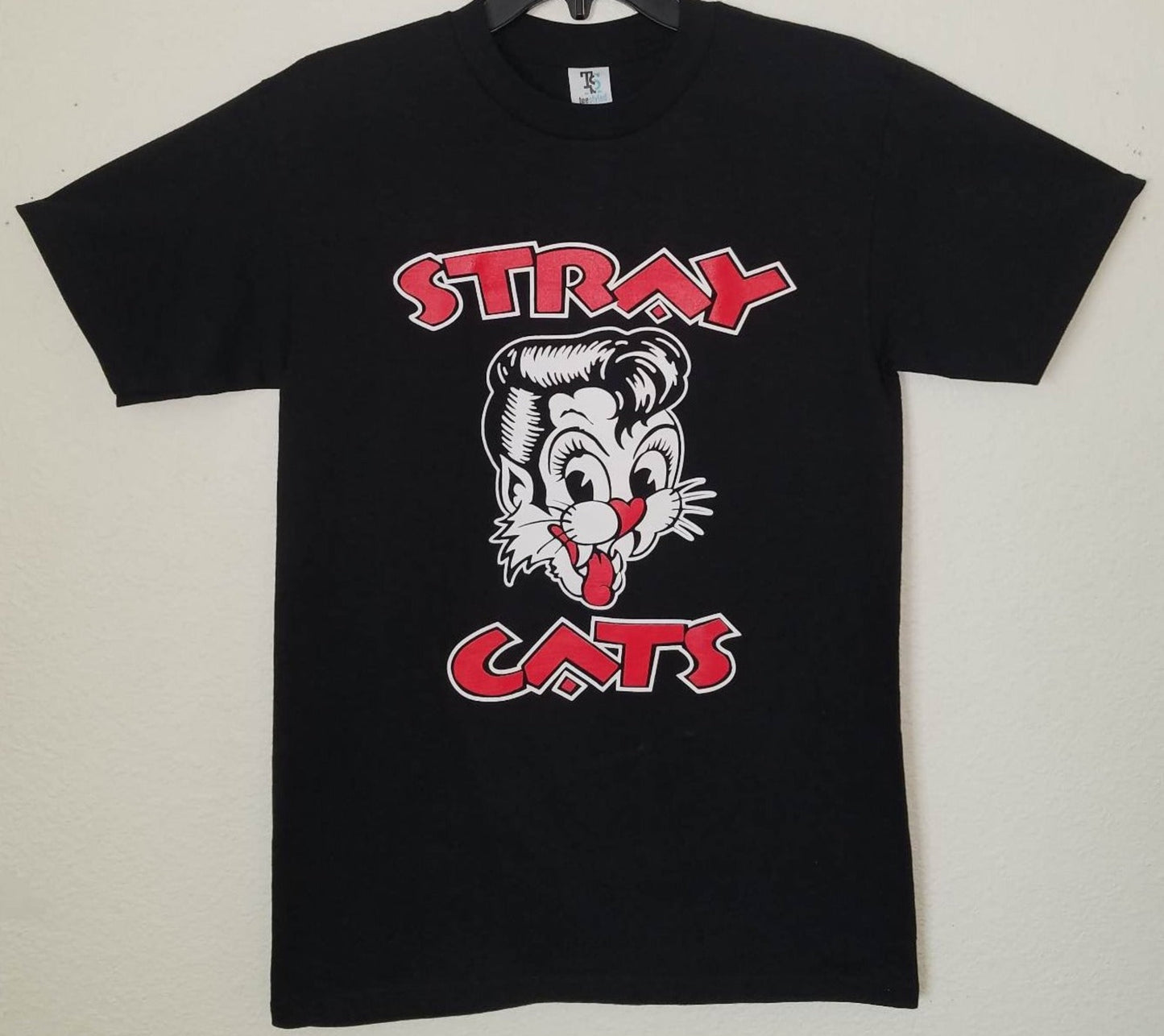 Front view of Stray Cats retro cat head graphic T-shirt featuring cartoon cat face and bold red lettering on black tee