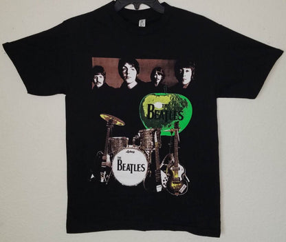 Front view of The Beatles green apple graphic T-shirt featuring band portrait and instruments printed in silkscreen on black cotton tee