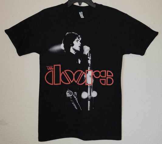 Front view of The Doors In Concert graphic T-shirt featuring Jim Morrison performing live with red logo printed in silkscreen on black cotton tee