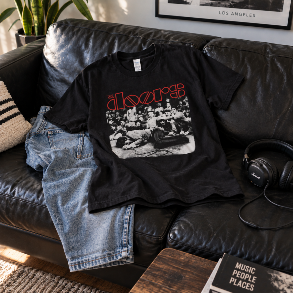 The Doors Jim Morrison Frankfurt 1968 adult unisex graphic T-shirt displayed on a black leather couch, sizes S–3XL