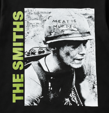 Black adult unisex The Smiths Meat Is Murder alternative rock T-shirt featuring the classic album artwork with bold green lettering and a distressed finish, available in sizes Small through 3X-Large.