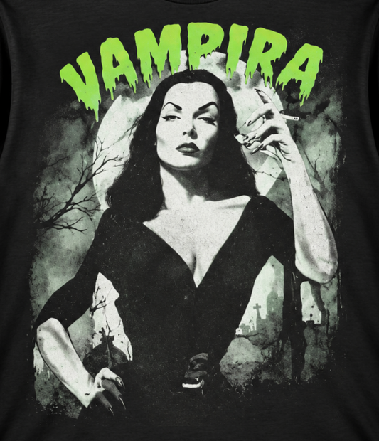 Close-up of the Vampira The Glamour Ghoul black T-shirt showing her dramatic black dress, dark makeup and bright green VAMPIRA lettering.