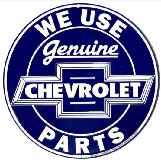 We Use Genuine Chevrolet Parts embossed round aluminum sign featuring classic Chevrolet bowtie lettering inspired by 1940s and 1950s dealership signage, available in 12 inch and 24 inch diameter.